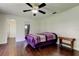 This bedroom is naturally lit with a fan and hardwood floors at 1402 Provincetown Cir, Lutz, FL 33549