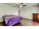 Bedroom featuring hardwood floors, a fan, and ample closet space at 1402 Provincetown Cir, Lutz, FL 33549