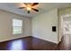 Bedroom with wood floors, natural light from a window, and a ceiling fan at 1402 Provincetown Cir, Lutz, FL 33549