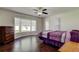 Cozy bedroom featuring hardwood floors, a bay window, and ample natural light at 1402 Provincetown Cir, Lutz, FL 33549