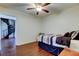 A simple bedroom featuring dark wood flooring, a spiral staircase, and a small bed at 1402 Provincetown Cir, Lutz, FL 33549