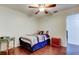 A simple bedroom featuring dark wood flooring and a window at 1402 Provincetown Cir, Lutz, FL 33549