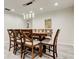 Dining room featuring an extending wooden table with seating for eight and modern light fixtures at 1402 Provincetown Cir, Lutz, FL 33549