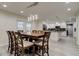 This dining room offers an overhanging light fixture and an open concept to the kitchen at 1402 Provincetown Cir, Lutz, FL 33549