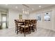 Bright dining area with an overhanging light fixture and seating for eight at 1402 Provincetown Cir, Lutz, FL 33549