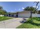 Attractive single-story home with a paved driveway and manicured lawn, creating curb appeal at 1402 Provincetown Cir, Lutz, FL 33549