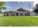 Charming single-story home featuring a manicured lawn and inviting curb appeal on a sunny day at 1402 Provincetown Cir, Lutz, FL 33549