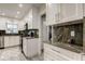 Bright kitchen featuring white cabinets, stainless steel appliances, and granite countertops at 1402 Provincetown Cir, Lutz, FL 33549