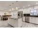 Open concept kitchen featuring a large island, stainless steel appliances, and a dining area at 1402 Provincetown Cir, Lutz, FL 33549
