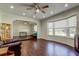 Bright and open living room featuring hardwood floors, crown molding, and large windows at 1402 Provincetown Cir, Lutz, FL 33549