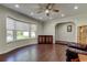 Bright living room featuring hardwood floors, a ceiling fan, and a large bay window at 1402 Provincetown Cir, Lutz, FL 33549