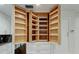 Open pantry featuring a wooden shelving system for organized storage at 1402 Provincetown Cir, Lutz, FL 33549