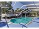 Outdoor pool area with full enclosure and partial home view at 1402 Provincetown Cir, Lutz, FL 33549