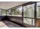 View from screened porch with greenery in the distance at 1402 Provincetown Cir, Lutz, FL 33549