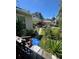 Exterior view of a backyard with lush green grass, tropical foliage, shed, and trees at 1420 36Th N Ave, St Petersburg, FL 33704