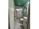 Compact bathroom features black and white tiled floors, walk-in shower, and vanity at 1420 36Th N Ave, St Petersburg, FL 33704