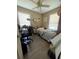 Small bedroom with wood laminate flooring, two windows, ceiling fan, and a desk at 1420 36Th N Ave, St Petersburg, FL 33704