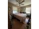 Neutral bedroom featuring a ceiling fan, natural light, wood laminate flooring, and bed at 1420 36Th N Ave, St Petersburg, FL 33704