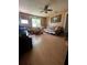 Neutral living room with ceiling fan, futon, natural light, and wood laminate floors at 1420 36Th N Ave, St Petersburg, FL 33704