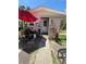Exterior view of the shed with a red umbrella, white door, and tropical plants at 1420 36Th N Ave, St Petersburg, FL 33704