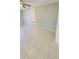 Large bedroom with tile floors, fresh paint, and an open doorway to the rest of the house at 1507 W Le Compte Dr, Tampa, FL 33604