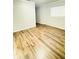 Bright bedroom featuring hardwood floors and a window, creating a cozy and inviting space at 1507 W Le Compte Dr, Tampa, FL 33604