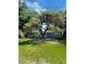 Charming single-story home with a mature tree providing shade in the front yard at 1507 W Le Compte Dr, Tampa, FL 33604