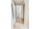 Tiled hallway providing access to multiple rooms in the home; all with neutral color palettes at 1507 W Le Compte Dr, Tampa, FL 33604