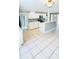 Open concept kitchen with white cabinets, tile floors, and modern appliances at 1507 W Le Compte Dr, Tampa, FL 33604
