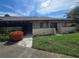 Charming single-story home with a well-maintained lawn and vibrant red bushes under a sunny sky at 1508 16Th Se Cir, Largo, FL 33771