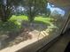 View of front yard with plants and green grass visible through the window at 1508 16Th Se Cir, Largo, FL 33771