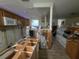 Spacious kitchen undergoing renovation, featuring unfinished cabinetry and updated flooring at 1508 16Th Se Cir, Largo, FL 33771