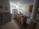 Unfinished kitchen with exposed framework and new wood-look tile flooring at 1508 16Th Se Cir, Largo, FL 33771