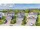 Aerial view of well-maintained homes with manicured lawns, near a lush pond at 1634 Acadia Harbor Pl, Brandon, FL 33511