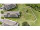 Aerial view of a home with a large, fenced backyard surrounded by lush greenery at 1634 Acadia Harbor Pl, Brandon, FL 33511