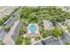 Aerial view showcases a community pool surrounded by lush landscaping and residential buildings at 1634 Acadia Harbor Pl, Brandon, FL 33511
