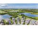 Aerial view of homes in a cul-de-sac near a pond and wooded area at 1634 Acadia Harbor Pl, Brandon, FL 33511