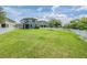 This home features a large, grassy backyard enclosed by a white picket fence at 1634 Acadia Harbor Pl, Brandon, FL 33511