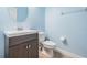 Powder bathroom featuring blue walls, gray vanity and white fixtures at 1634 Acadia Harbor Pl, Brandon, FL 33511