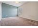 Carpeted bedroom featuring a window with blinds, a ceiling fan, and a blue accent wall at 1634 Acadia Harbor Pl, Brandon, FL 33511