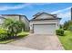Two-story home features a two-car garage and a brick-paved driveway at 1634 Acadia Harbor Pl, Brandon, FL 33511