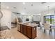 Open concept kitchen with a large island and seamless transition to the dining area at 1634 Acadia Harbor Pl, Brandon, FL 33511