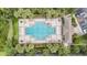 Aerial view of the community pool with lounge chairs, tables, palm trees, and well-maintained landscaping at 1634 Acadia Harbor Pl, Brandon, FL 33511