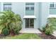 Relax on your private patio area surrounded by palm trees and greenery at 1706 Belleair Forest Dr # 146, Belleair, FL 33756