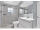 Bright bathroom features a shower over bath with a single sink vanity and large mirror at 1706 Belleair Forest Dr # 146, Belleair, FL 33756