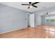 Bedroom featuring sleek ceiling fan, light hardwood floors and a window and closet with doors at 1706 Belleair Forest Dr # 146, Belleair, FL 33756