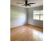 Bedroom featuring wood-look flooring, neutral walls and ceiling fan at 1706 Belleair Forest Dr # 146, Belleair, FL 33756