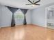 Spacious bedroom with gray accent walls and large window with gray drapes at 1706 Belleair Forest Dr # 146, Belleair, FL 33756