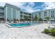 Enjoy the sparkling community pool surrounded by lush tropical landscaping and ample seating at 1706 Belleair Forest Dr # 146, Belleair, FL 33756