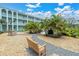 Charming courtyard with lush palm trees and inviting benches and stone pathways at 1706 Belleair Forest Dr # 146, Belleair, FL 33756